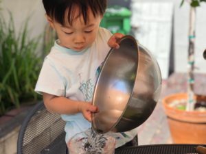 Even a two-year-old can get into water play. Bowls and other cooking utensils are fascinating for kids when they can fill them with water.