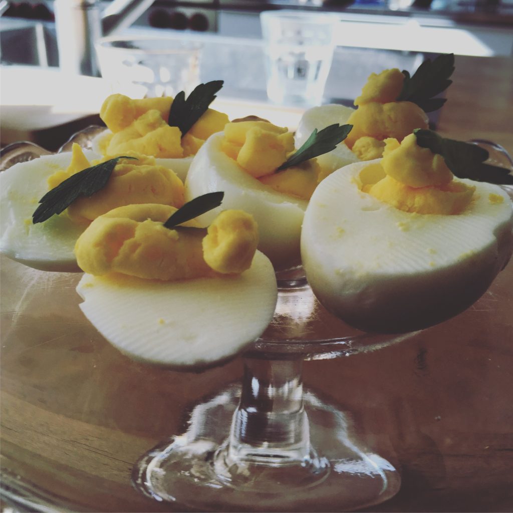 A three-year-old made these deviled eggs.  Plating them on a stemmed cake plate gives the snack an elegant touch to charm a child.