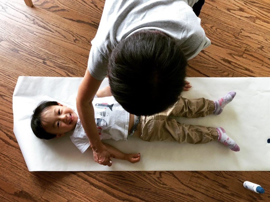 Have the child lie on the floor over a large sheet of paper and trace the child's silhouette to make a paper pattern.
