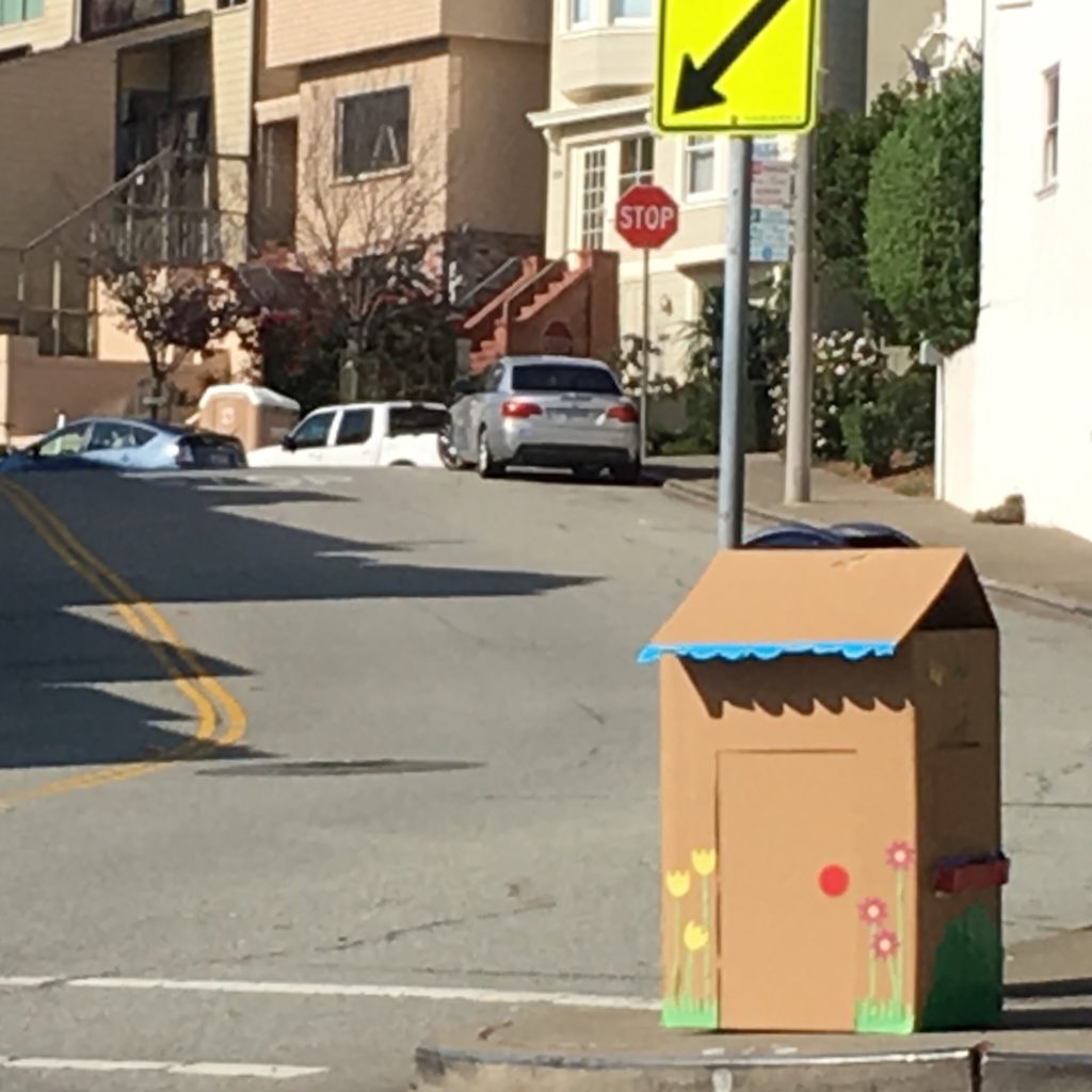 The DIY cardboard house sits on the curb, ready to be dismantled for the recycle truck.