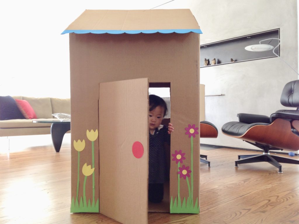 A large cardboard carton can be turned into a playhouse for a young child.