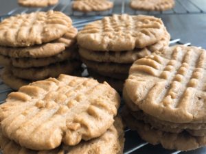 Crisp Grandma's Peanut Butter Cookies cool on racks.