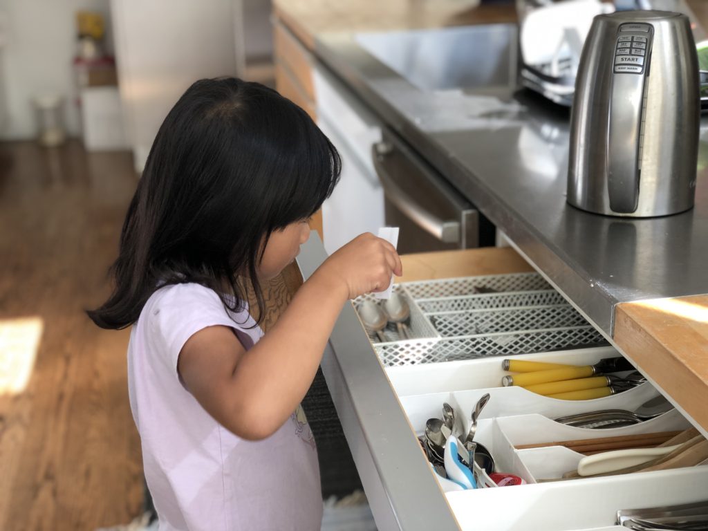 A clue takes Miss T to the utensil drawer of the kitchen, where she finds the next clue.