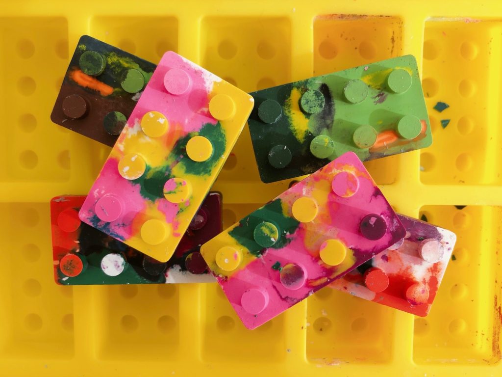 Use silicone molds to make shaped rainbow crayons like this one for Lego-style building blocks.