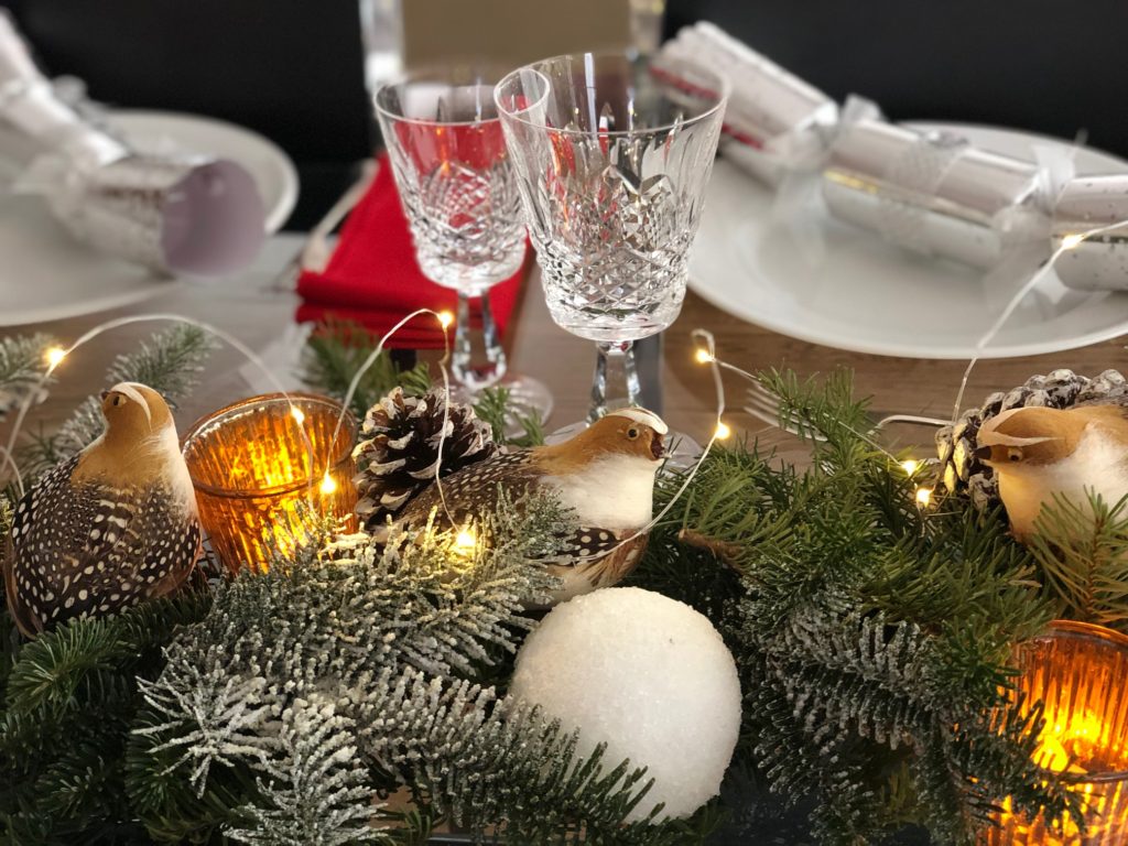 A close-up of the Christmas centerpiece shows the micro lights, epsom-salt-covered snowballs, and artificial snow sprayed on the branches.