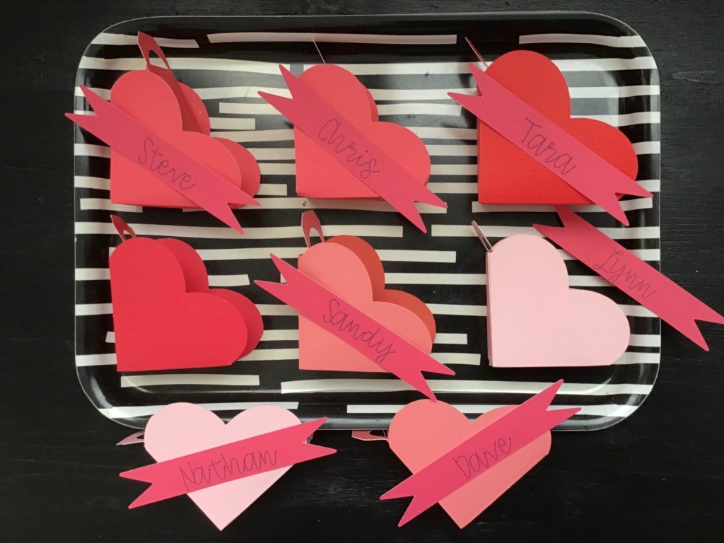 Valentine heart boxes will be filled with truffles; banners with each family member's name will turn these favors into place cards.