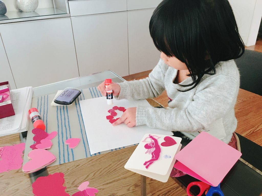 Give children hearts, doilies and other decorations to make valentines for the family.