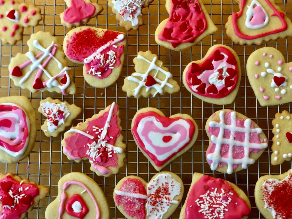 Valentine sugar cookies were rolled and cut by a five-year-old, and iced by her afterwards.