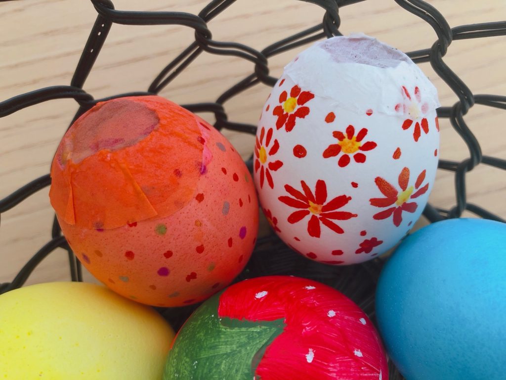 Each egg has been hollowed out, decorated, filled with confetti, and glued close with tissue paper.