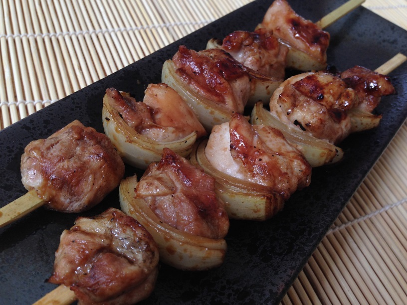 Yakitori, grilled chicken skewers, are bathed in a delicious soy sauce mixture while grilling.