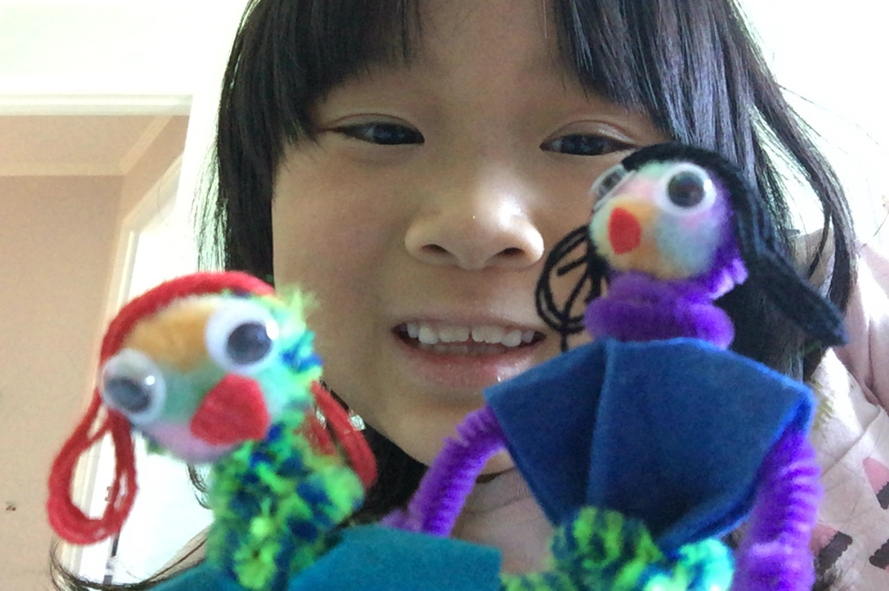 A child makes dolls with instructions given long distance by grandma.