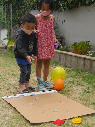 A simple game for your summer celebration: draw circles on cardboard and place prizes on them that kids can win by tossing a bean bag into the circle.