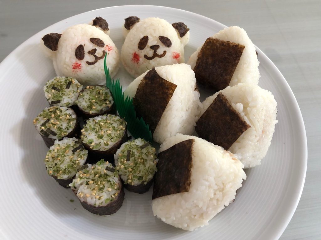Easy-to-eat omusubi and onigiri, rice balls, were served at the family get-together. The kids had panda versions.