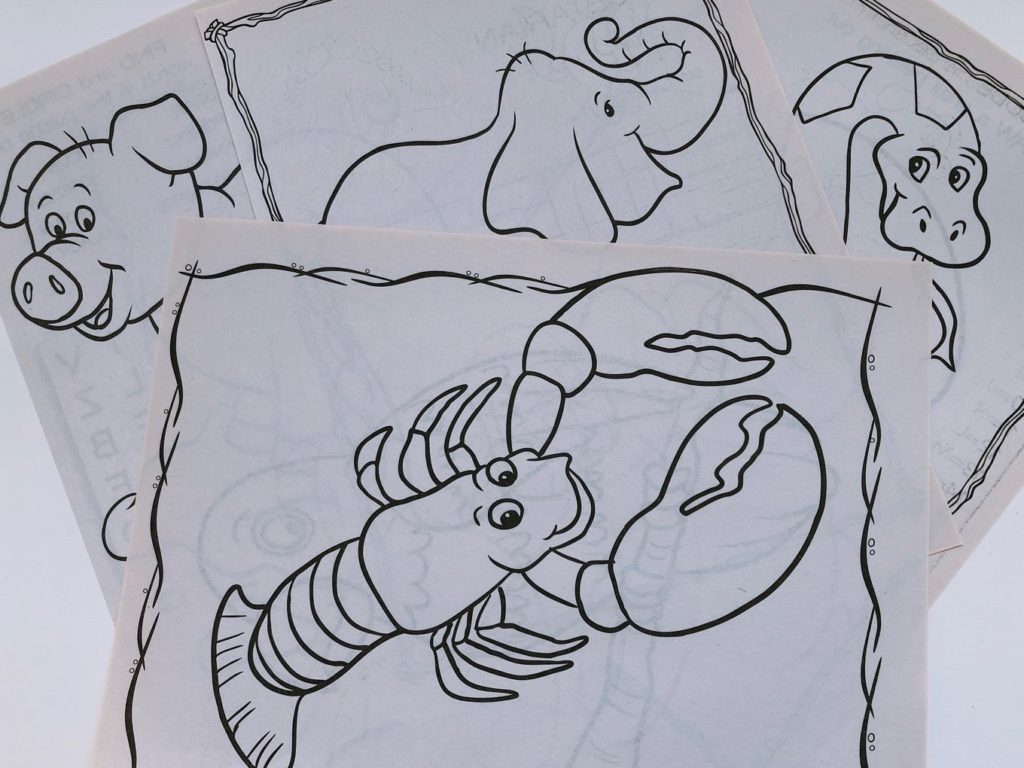 Simple line images from coloring books can be transferred to cloth with carbon paper, then embroidered.