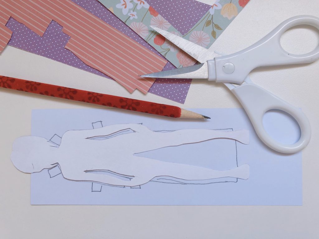 To make paper doll clothes, trace the doll's silhouette on the backside of patterned paper, add tabs and cut out.

