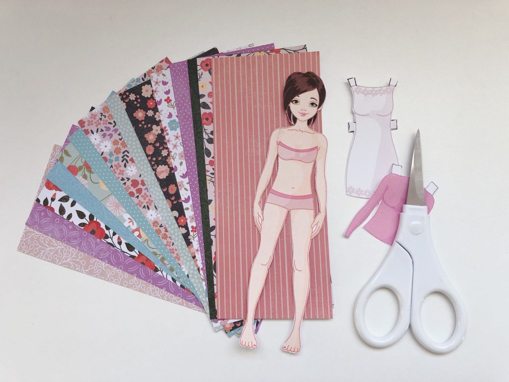 Package pretty patterned papers with a paper doll to use as "fabric" in making doll outfits.
