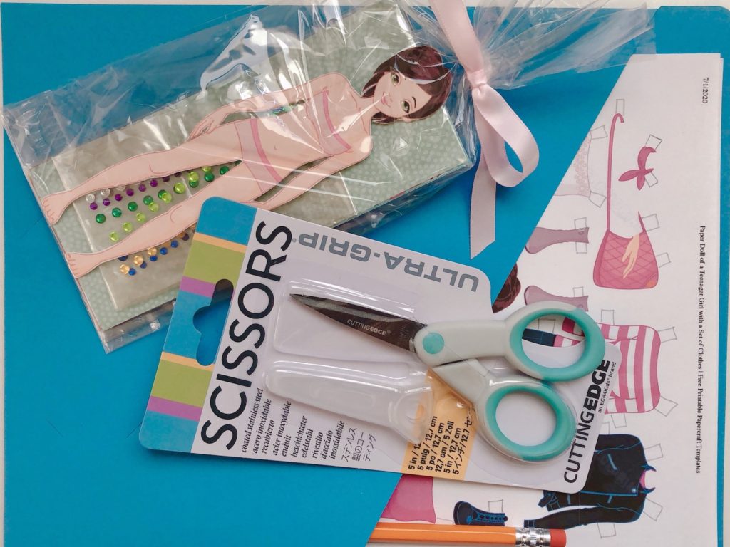 For a paper doll kit, provide colorful papers, "jewels," scissors and a pencil, along with a cut-out doll.
