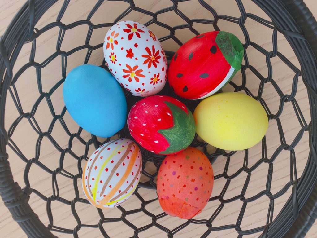 A set of confetti eggs colored with acrylic paints, marking pens and food coloring dyes.
