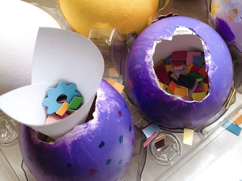 To fill the eggs with confetti, roll up a scrap of paper to form a funnel.
