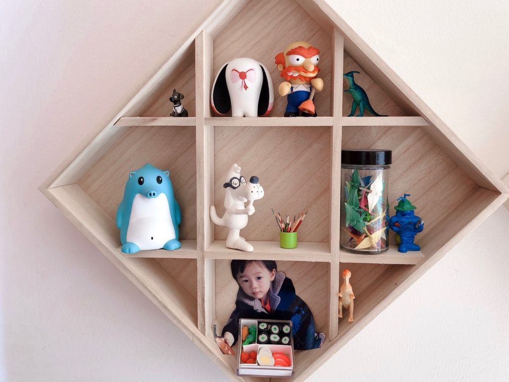 A wooden box used to package Japanese bowls make a fin shelf to display desk toys in my office.