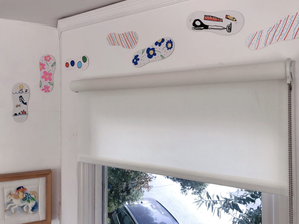 Colorful cardboard "footprints" make fun wall art in my craft room.