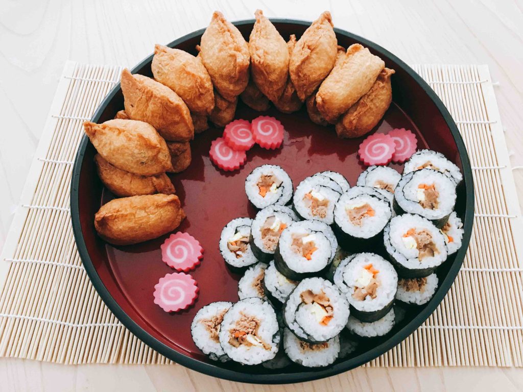 Sushi made at home for the New Year features sushi stuffed in deep-fried tofu pockets, and sushi rolls. They're made with the same sushi rice.