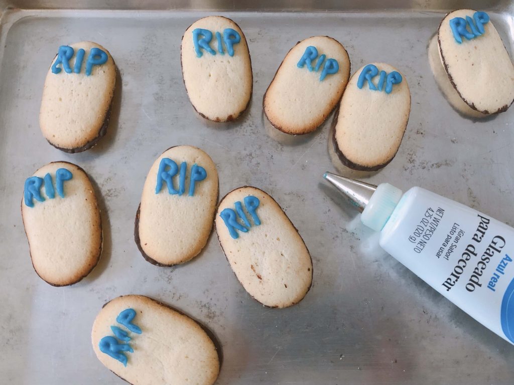 Use tube icing to pipe "RIP" on Milano cookies to turn them into tombstones for Halloween cupcakes.
