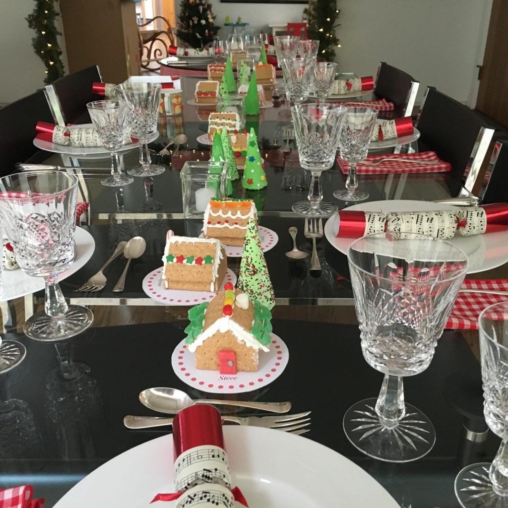 This table centerpiece features gingerbread houses made of graham crackers and frosted ice cream cones for trees. 