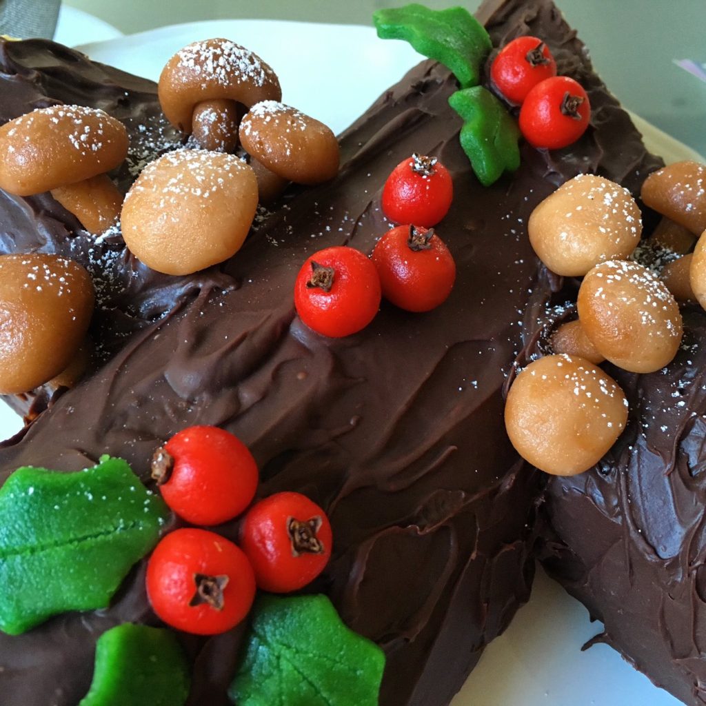 Buche de Noel is the traditional Christmas cake shaped into a yule log. This one is decorated with marzipan mushrooms and holly.