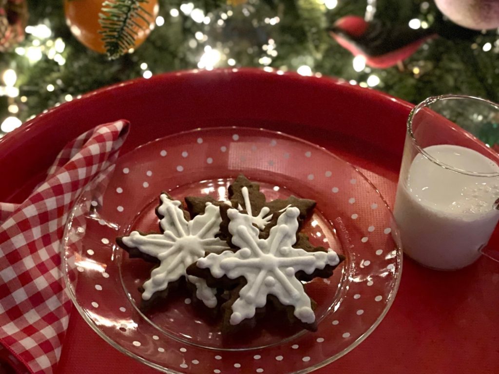 Snowflake chocolate cookies and milk are ready for Santa. 