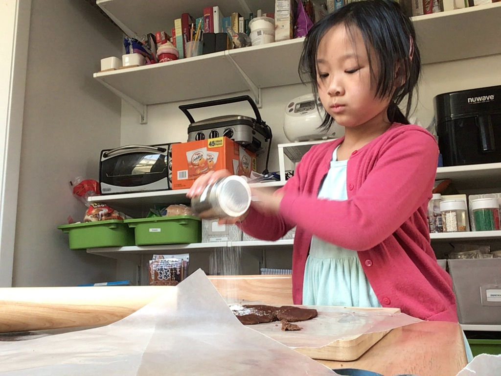 Fill a powdered sugar shaker with flour so kids can flour the dough to keep it from sticking.