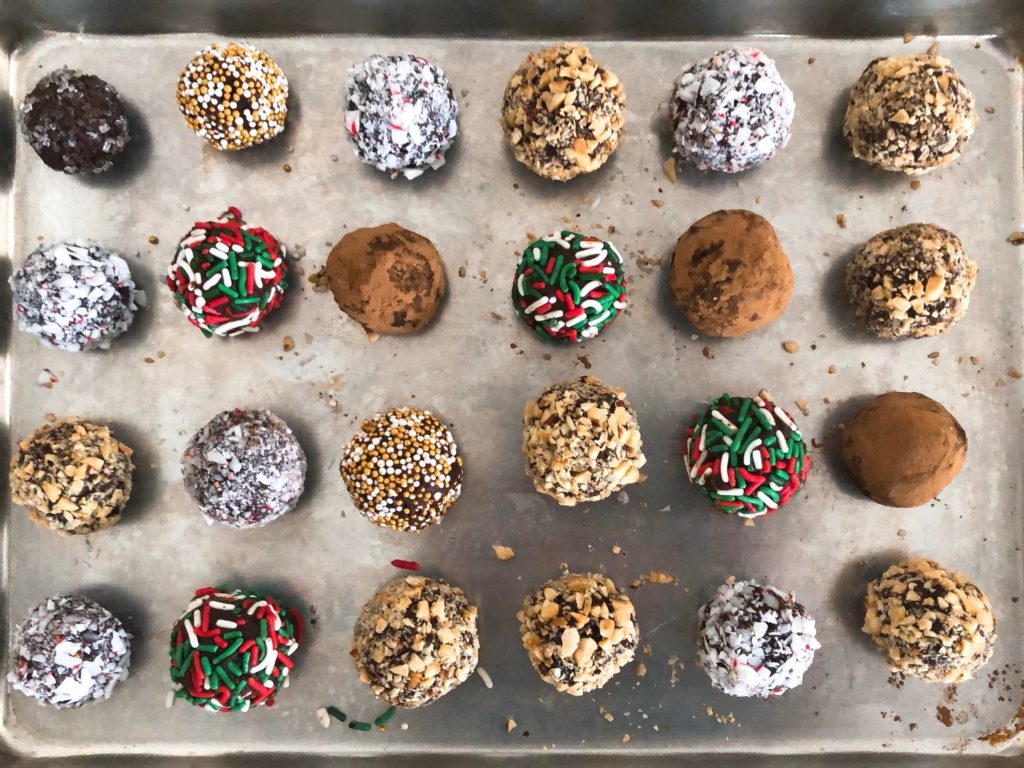 Christmas sweets:  truffles, in.a variety of coatings, are set to chill on a small baking sheet.