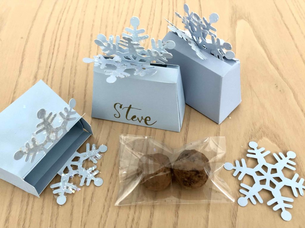 Truffles are tucked in cellophane bags and packed in little snowflake boxes.