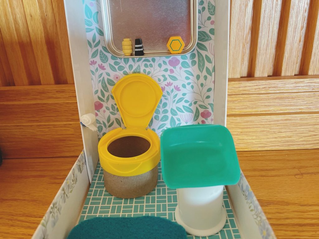 Make a powder room for a doll house with vitamin-pill toilet, dental floss cap sink, and tea tin mirror.