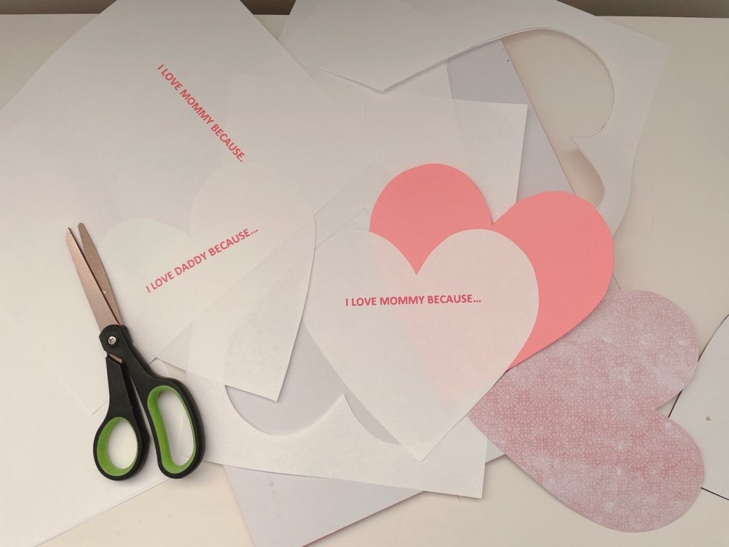 Paper hearts cut and ready for writing, drawing, and hole punching.