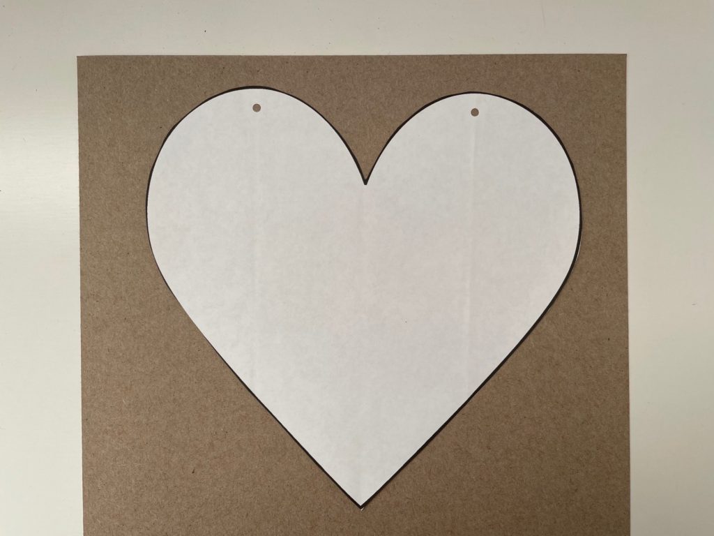 The first step in making DIY Valentines is to print a paper pattern and glue it to cardboard.