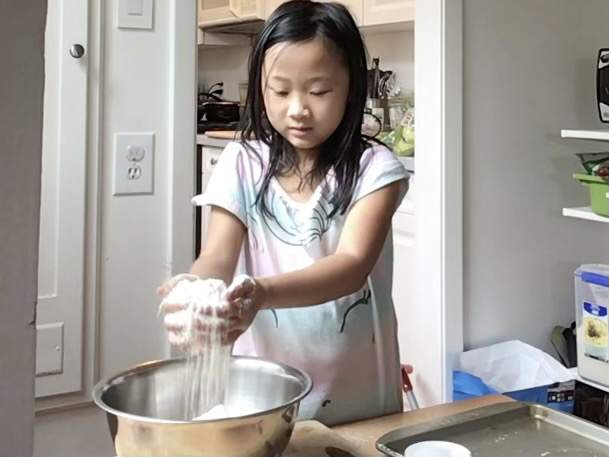 Miss T, now seven, makes Irish soda bread remotely with grandma. Ensure there's an adult to assist with the oven.