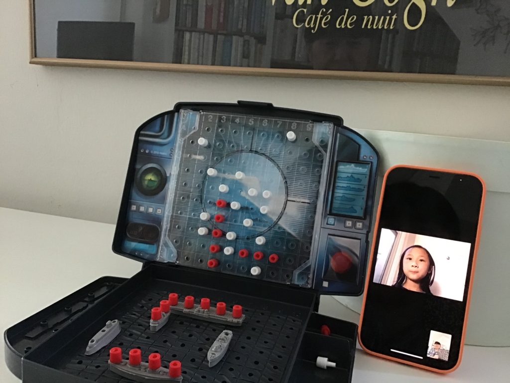 Battleship game in action, from grandma's side, with grandchild on FaceTime with her console.