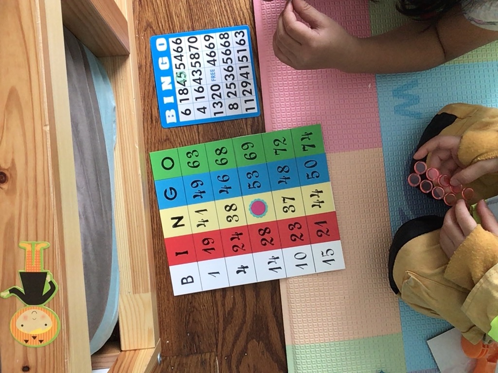 Kids playing bingo as a social distance game with grandma via FaceTime.