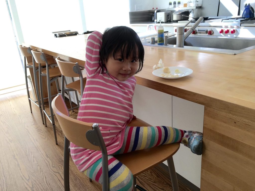 Miss T, after preschool, having a snack at her grandparents' house. Soon we'll resume the childcare duty.