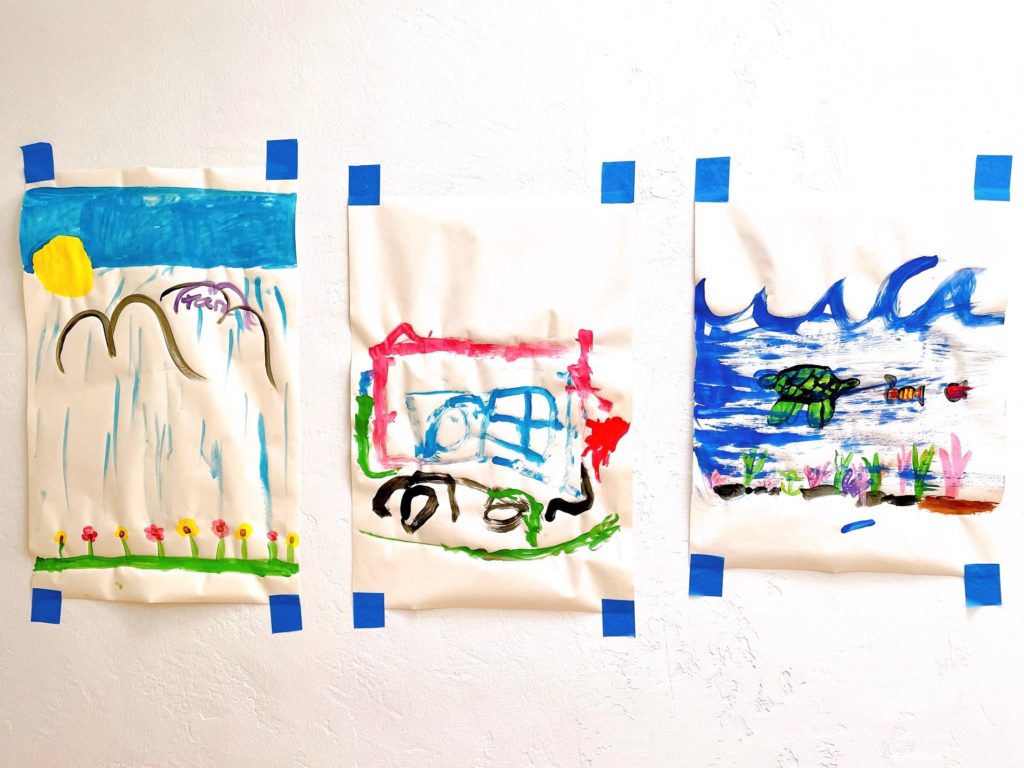 Use blue painter's tape to display children's artwork.