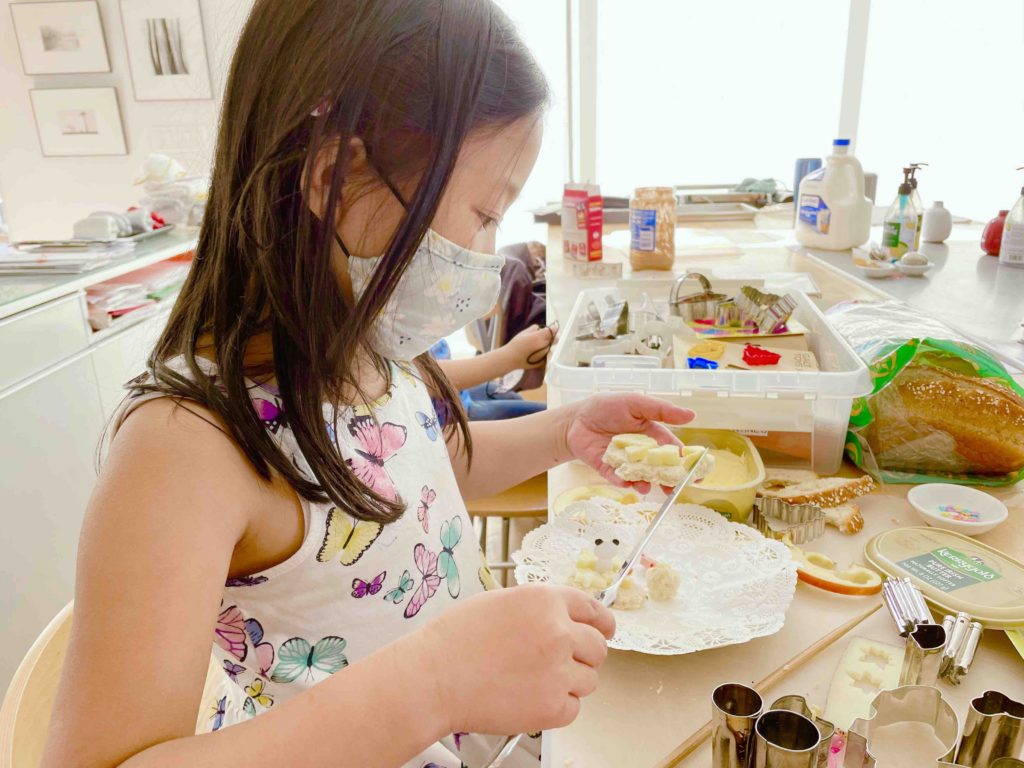 A seven-year-old can take the ingredients and tools to concoct her own healthy snack.