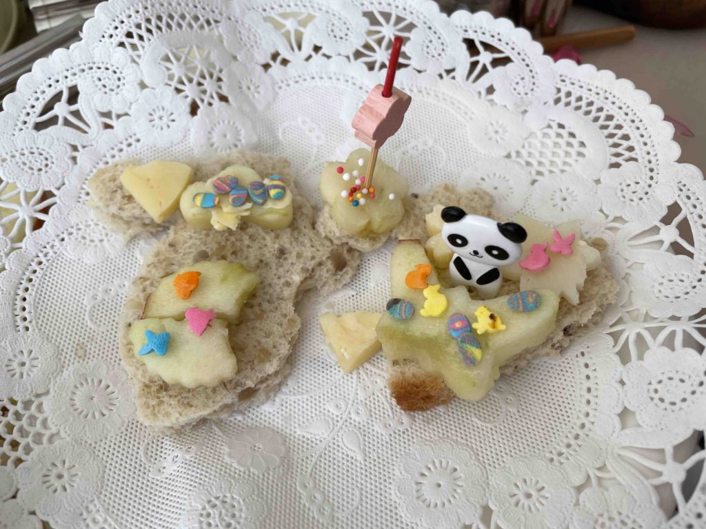 Going on eight, this child's sandwich features bread cut in shapes with cookie cutters, and cheese and apple cut with vegetable cutters. Food picks and candy sprinkles add eye appeal.