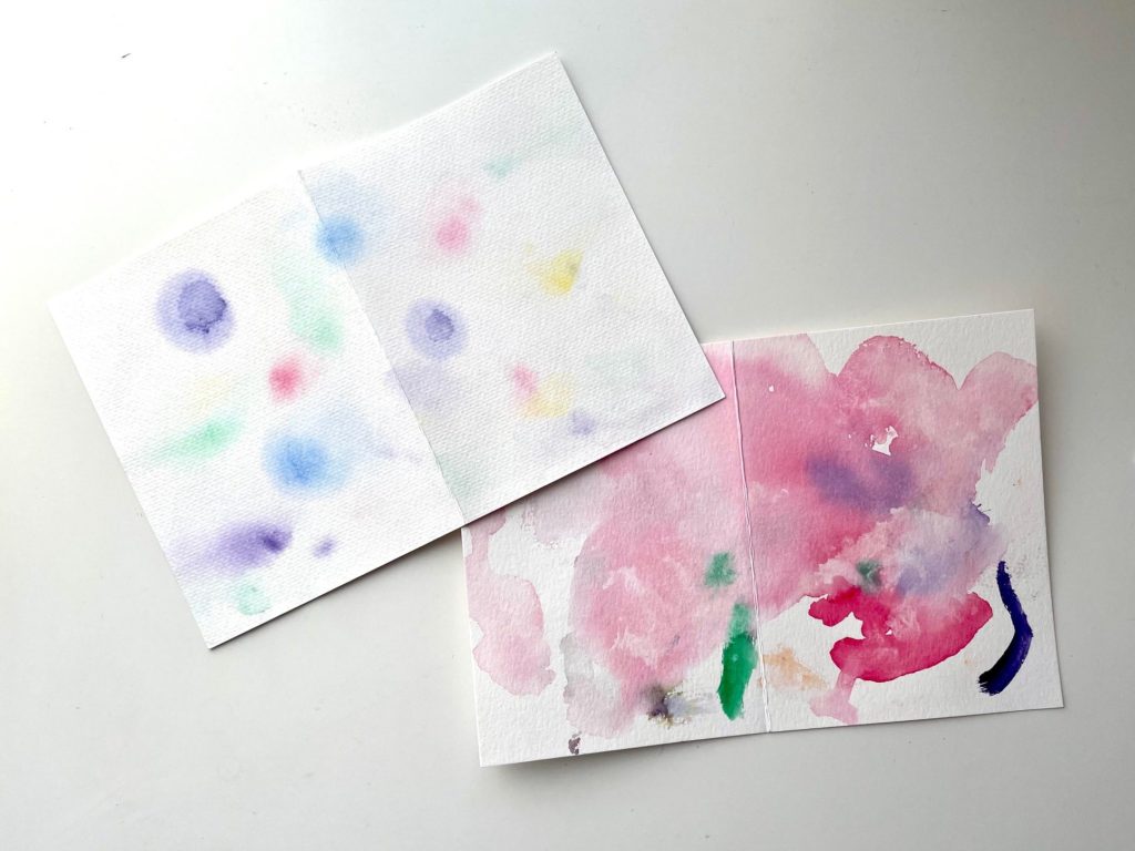 Wet watercolor paper with water and dab with watercolor paint to create abstract art for Mother's Day cards.