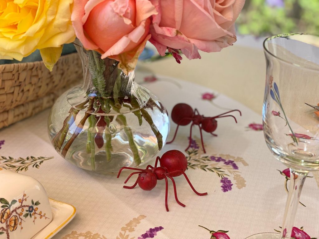 The table centerpiece is a vase of roses from my garden. The two ant sculptures add a touch of whimsy. 