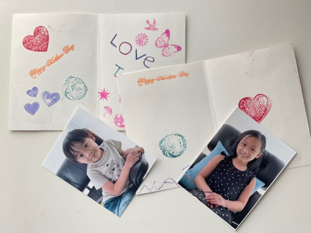 For the inside of the DIY card, use stamps to create designs and have the child write their name. Include a photo in each card.