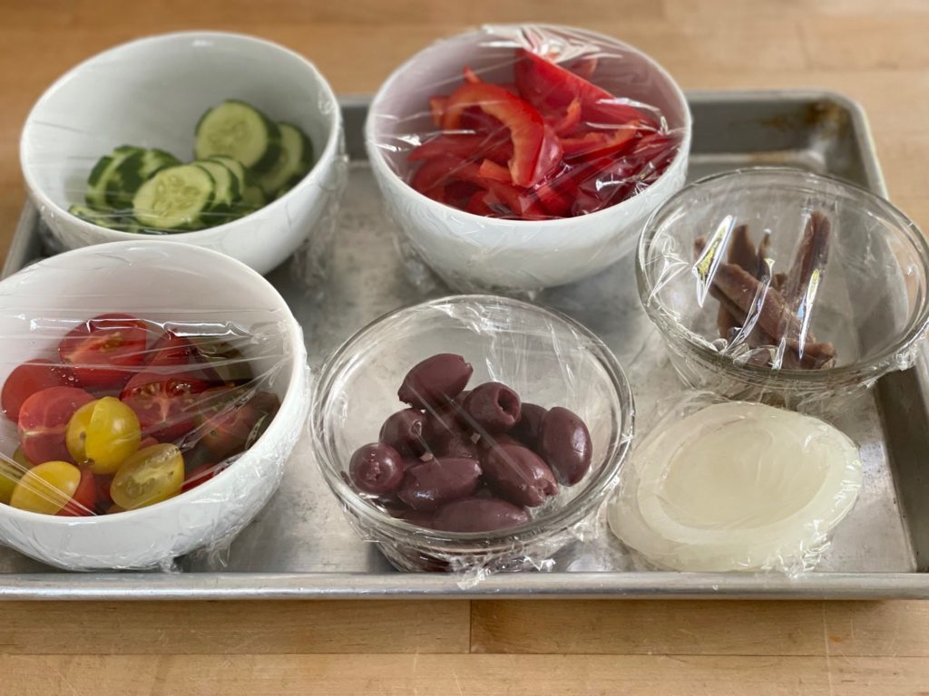 The ingredients in small bowls are prepped and ready so it's easy to assemble the salad when your guest arrives.
