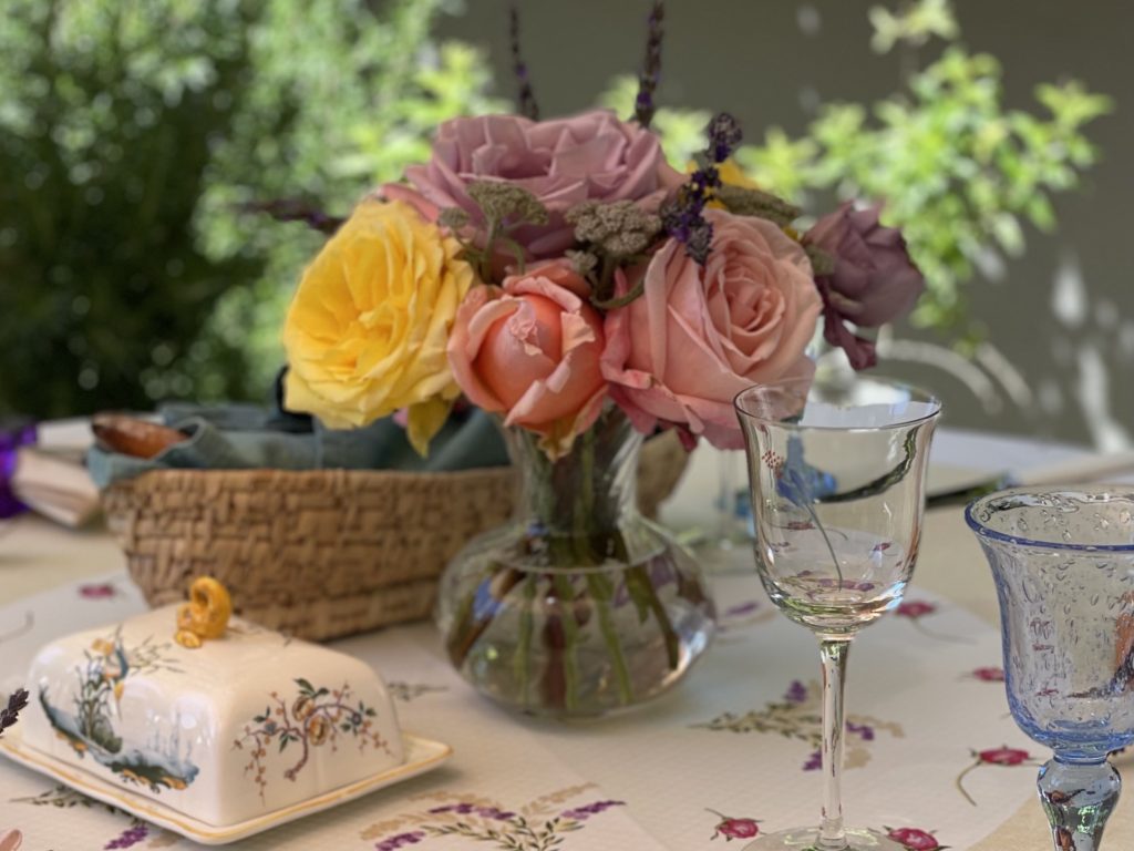 A bouquet of roses from the garden, French tableware. The perfect setting for an outdoor luncheon featuring Salade Nicoise.
