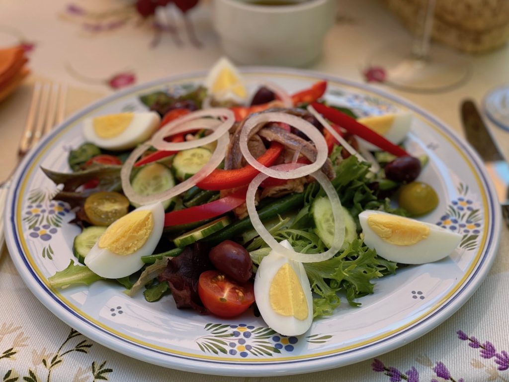 Salade Niçoise, named for Nice in the South of France, is a concoction of hard-boiled egg wedges, canned tuna, olives, and an assortment of vegetables.