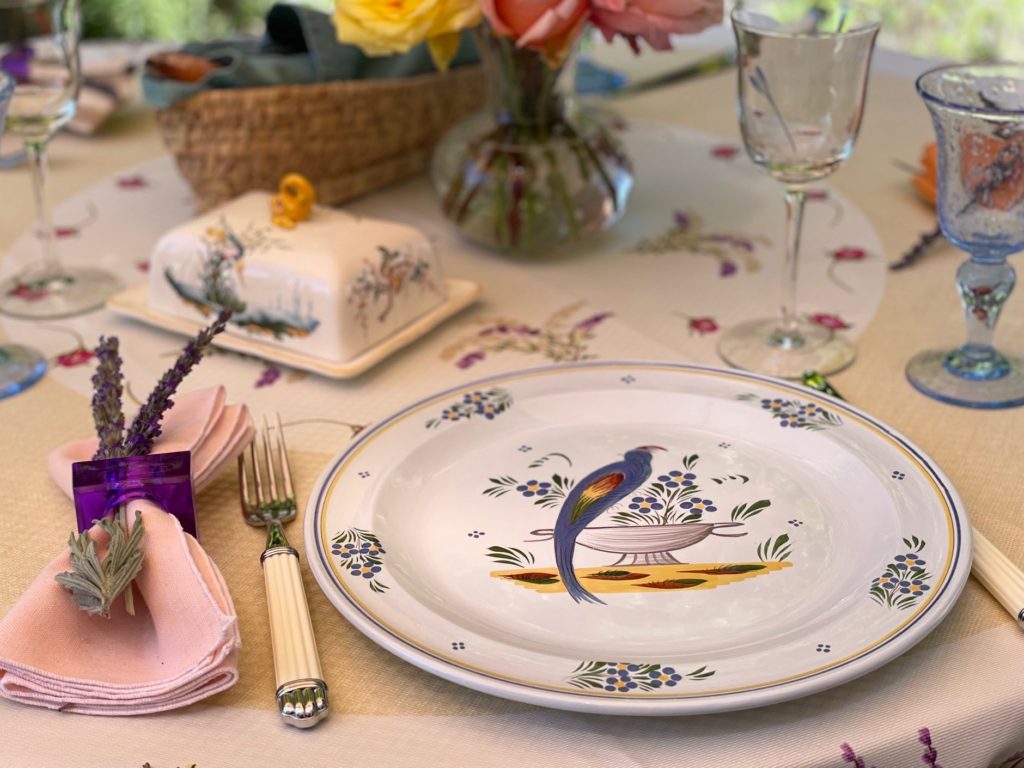 A table setting of china, flatware and stemware from France sets the mood for lunch. Lavender sprigs are tucked into napkins.